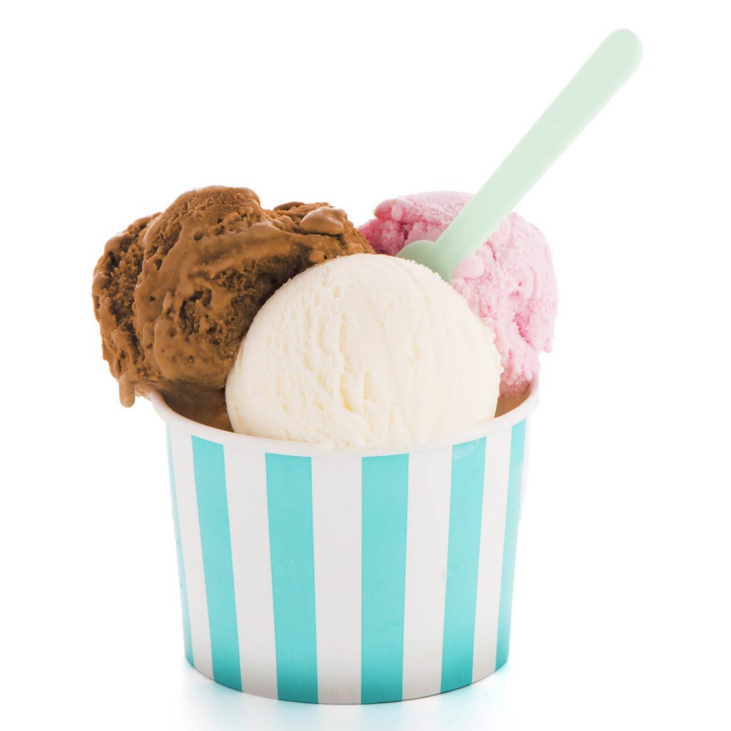 Ice cream scoop in paper cup on white background.