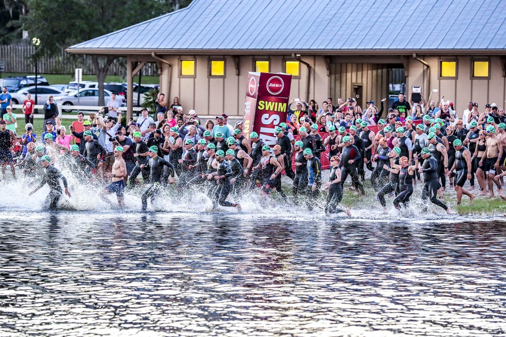 People running into a Lake to begin a race