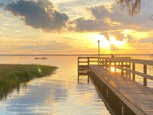 Photo of a boat dock on a lake at dawn.