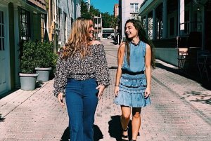 Two women walk down a cobblestone paved road in Mount Dora.