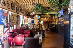 red couch on the left, wine bar on the right